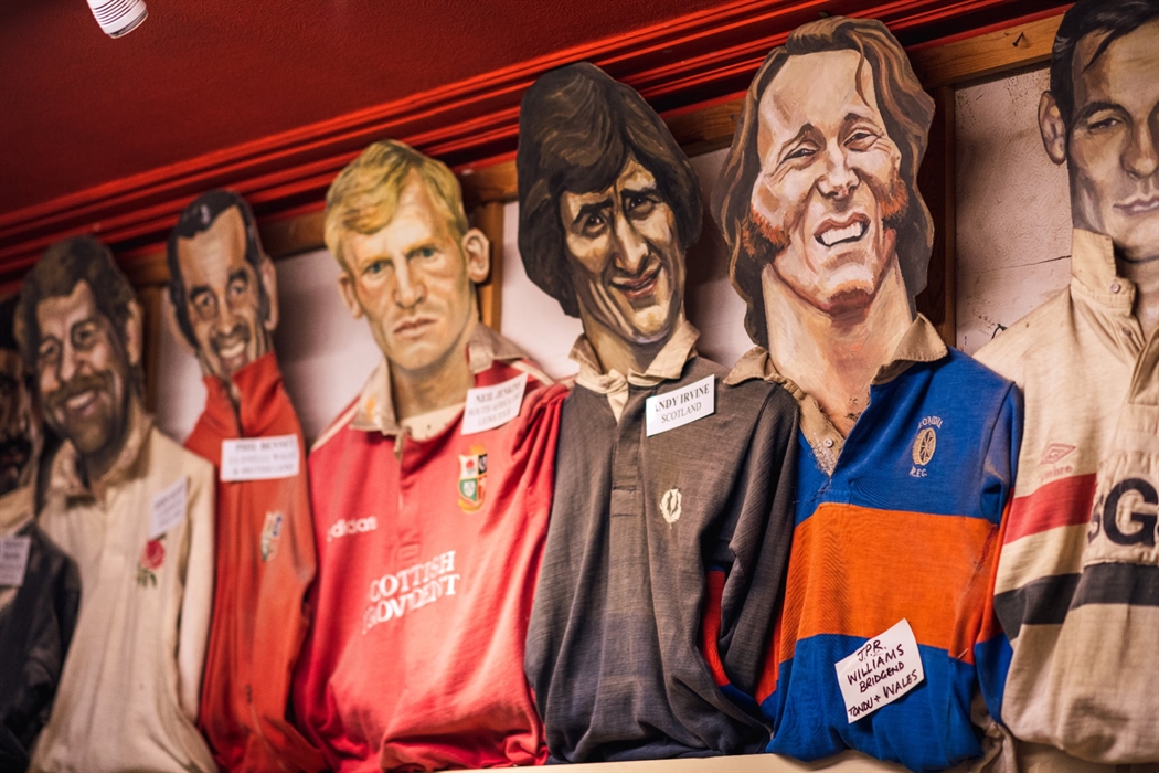 The photo shows hand painted heads of rugby stars with their shirts.
