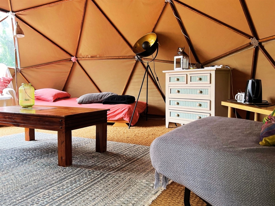 Geodome interior: single bed, futon, coffee table, tea-making facilities, chest of drawers, lamps