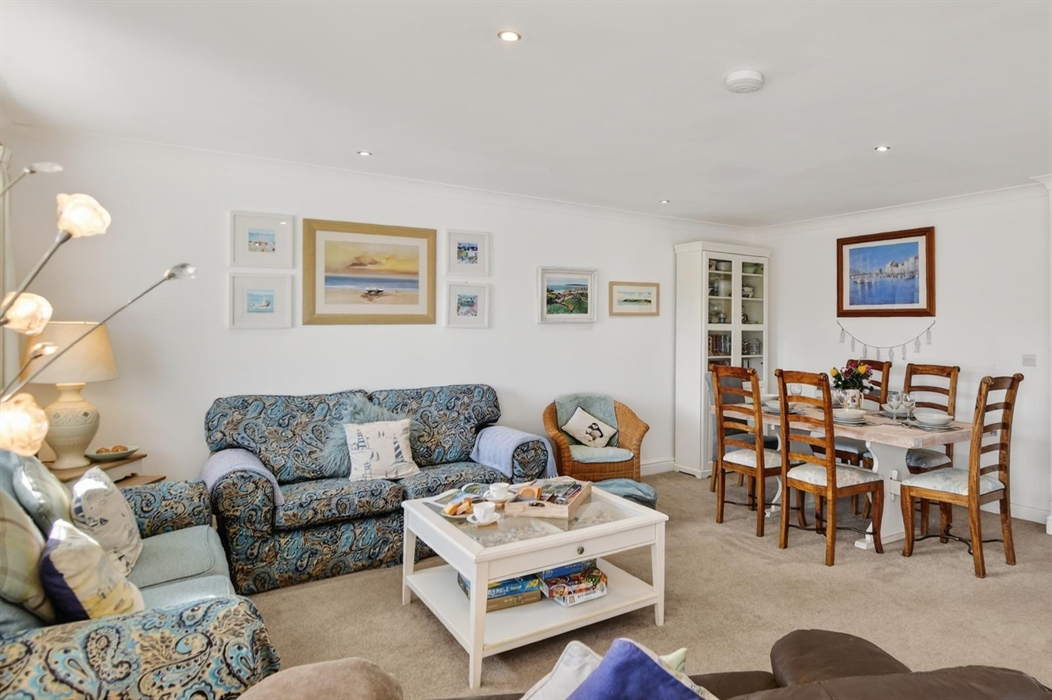The lounge, 3 x 2 seater settees, Coffee table, dining table for six, dresser with lovely china, books, and games.