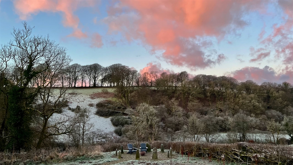 An early morning view across our Carmarthenshire valley with frost on the ground and pink clouds