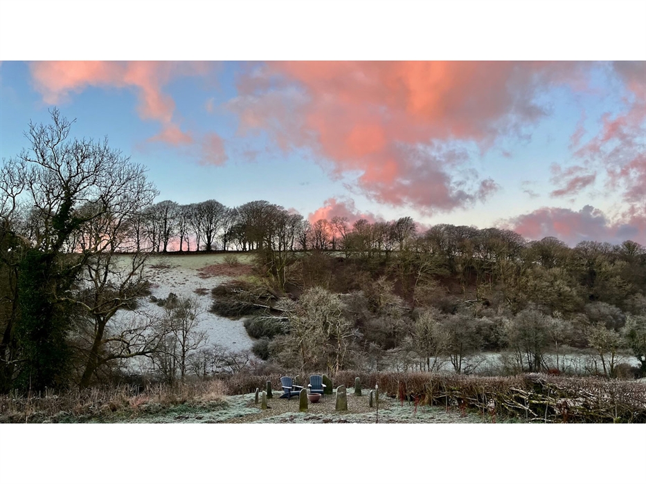 An early morning view across our Carmarthenshire valley with frost on the ground and pink clouds