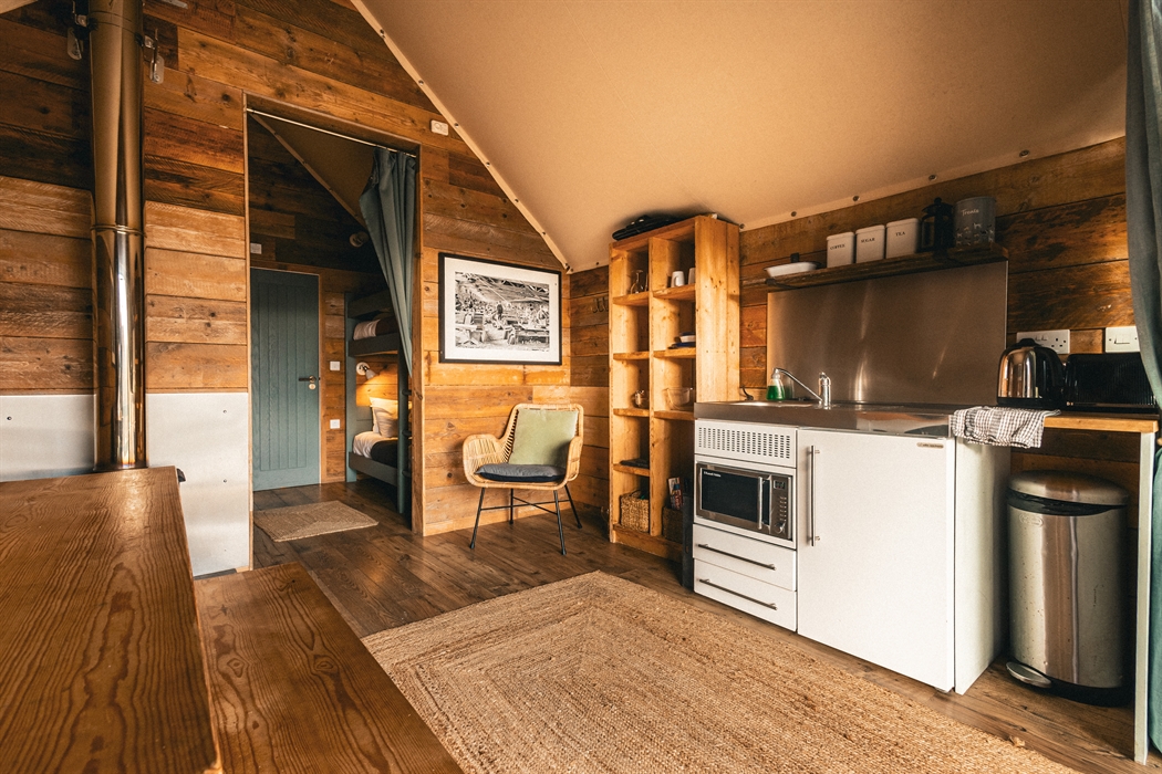 interior of llechwedd glamping tent kitchenette and bedroom area